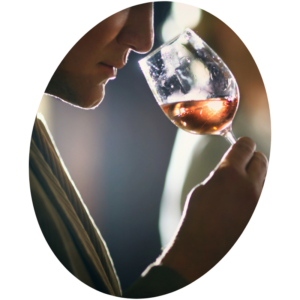 Un homme hume les arômes du vin avant de le goûter.